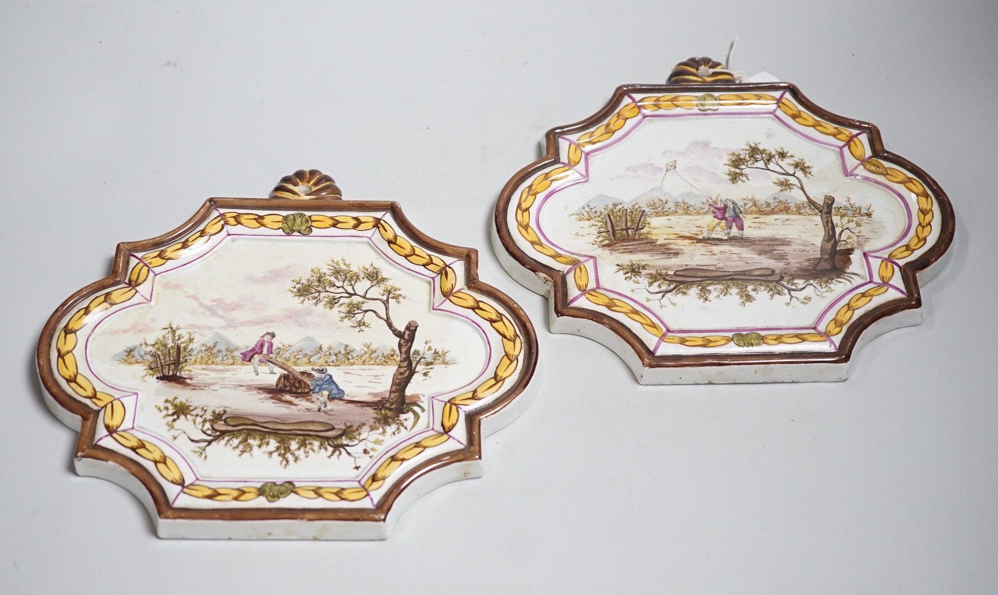 A pair of 19th century painted faience plaques in the style of Veuve Perrin 23cm